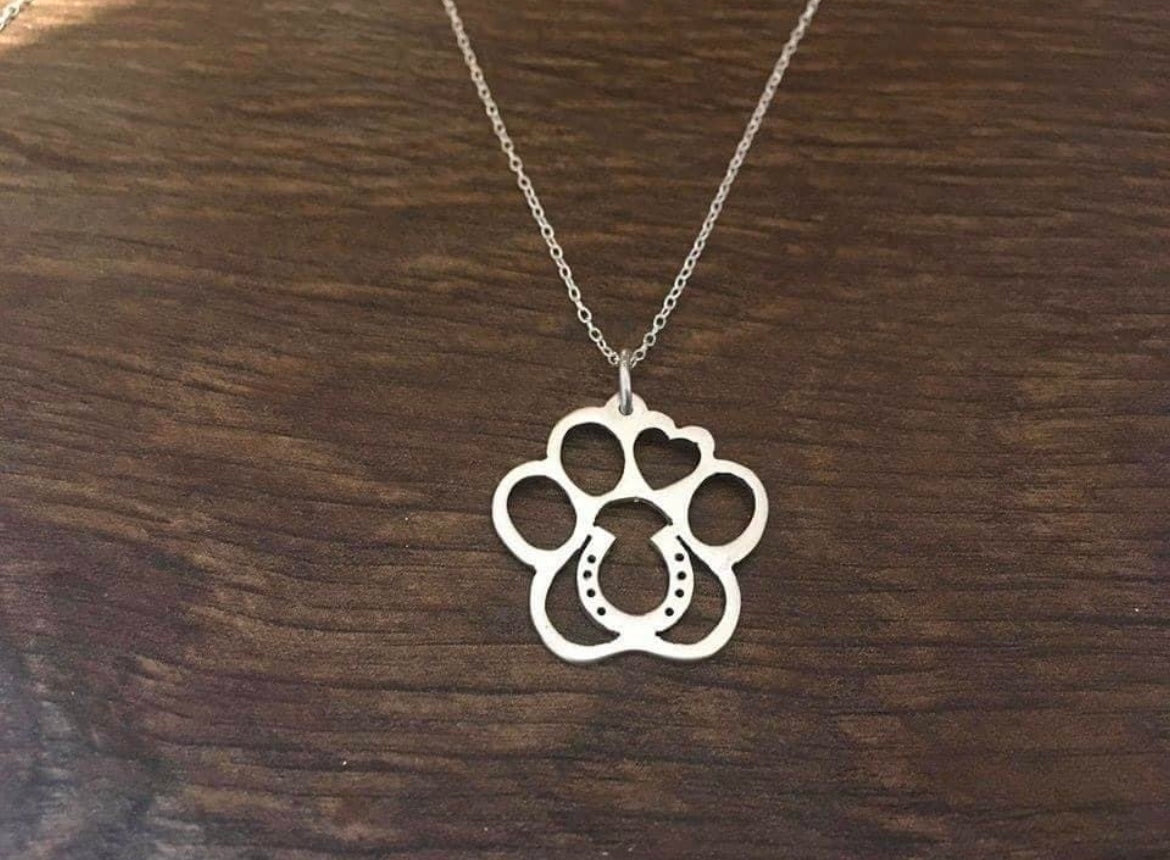 Horse shoe in a paw pendant